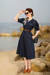 a lady in a v-neck denim top and a denim skirt
